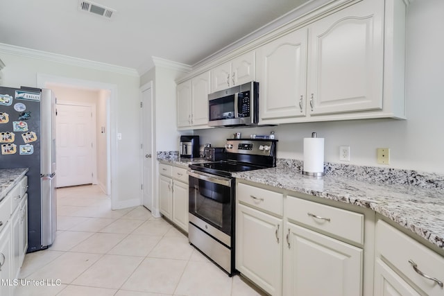 2901 Village Cir, Ocean Springs, MS 39564 - kitchen featuring appliances with stainless steel finishes, ornamental molding, light tile patterned floors, light stone countertops, and white cabinetry