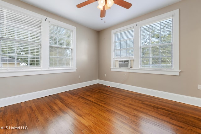 spare room featuring cooling unit, ceiling fan, and wood-type flooring