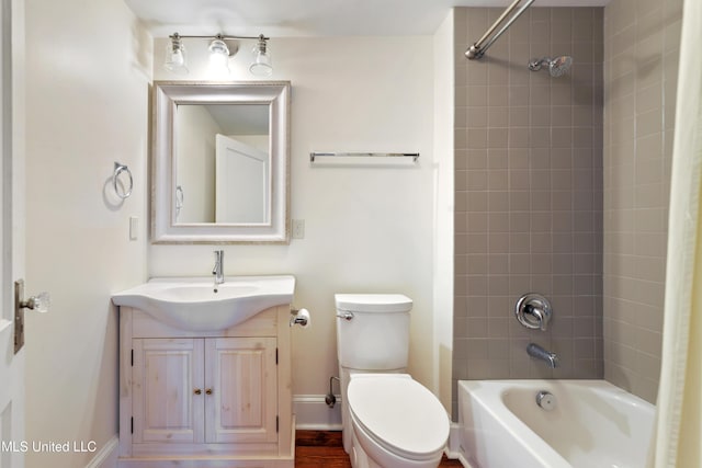 full bathroom with vanity, tiled shower / bath combo, and toilet