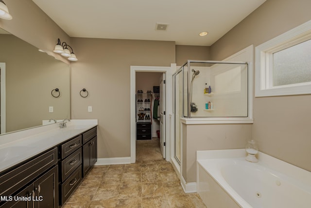 bathroom featuring shower with separate bathtub and vanity