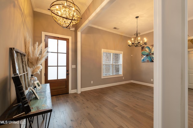 foyer featuring crown molding, hardwood / wood-style flooring, and a chandelier