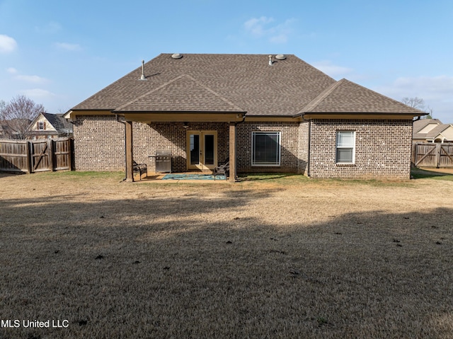 rear view of property featuring a yard and a patio area