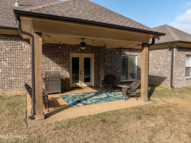 rear view of property featuring french doors, ceiling fan, and a patio area