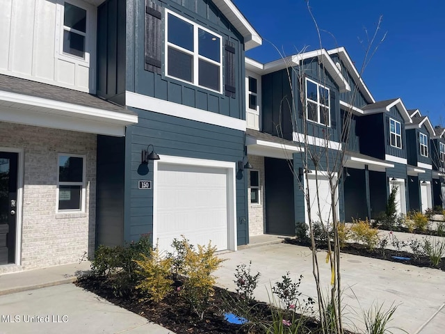 150 Debuys Rd, Biloxi, MS 39531 - view of property featuring a garage, board and batten siding, and brick siding