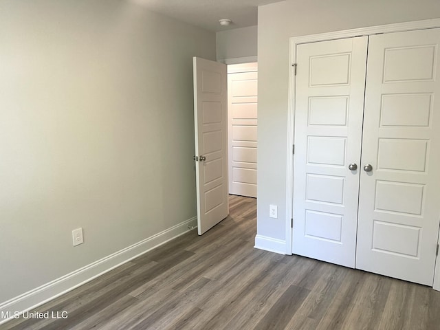 150 Debuys Rd, Biloxi, MS 39531 - unfurnished bedroom featuring baseboards, wood finished floors, and a closet