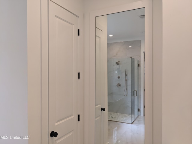 bathroom with a shower with door