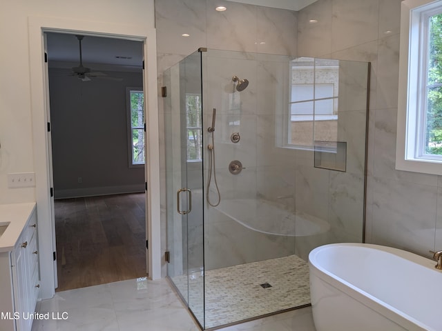 bathroom featuring vanity, hardwood / wood-style flooring, plenty of natural light, and separate shower and tub