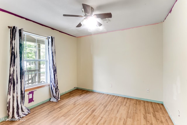 spare room featuring ceiling fan, ornamental molding, and light wood-type flooring