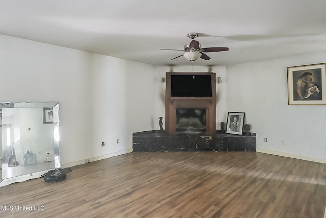 unfurnished living room with hardwood / wood-style flooring and ceiling fan