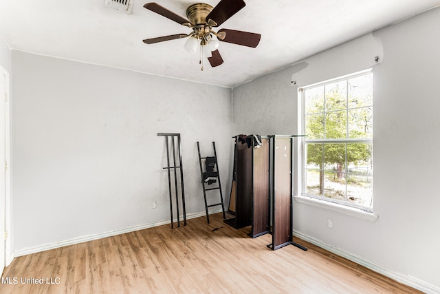 workout area featuring light hardwood / wood-style floors and ceiling fan