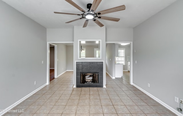 783 Whippoorwill Dr, Brandon, MS 39047 - unfurnished living room featuring a ceiling fan, a tile fireplace, and light tile patterned flooring