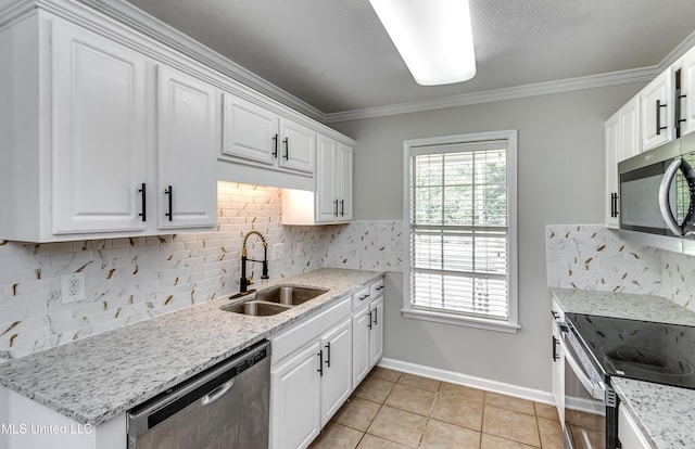 783 Whippoorwill Dr, Brandon, MS 39047 - kitchen featuring appliances with stainless steel finishes, white cabinetry, tasteful backsplash, light tile patterned floors, and ornamental molding