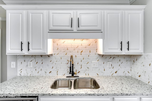 783 Whippoorwill Dr, Brandon, MS 39047 - kitchen with backsplash, white cabinetry, light stone countertops, and dishwashing machine