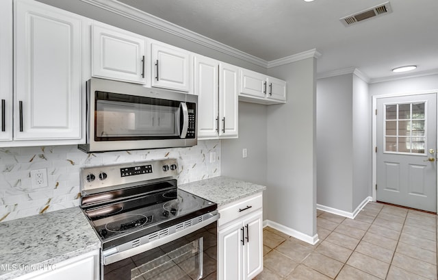 783 Whippoorwill Dr, Brandon, MS 39047 - kitchen featuring stainless steel appliances, white cabinetry, backsplash, ornamental molding, and light tile patterned floors