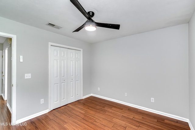 783 Whippoorwill Dr, Brandon, MS 39047 - unfurnished bedroom featuring wood finished floors, a closet, and a ceiling fan