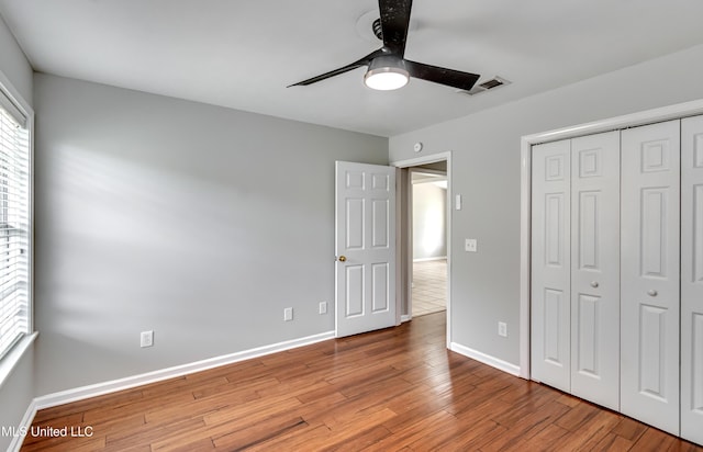 783 Whippoorwill Dr, Brandon, MS 39047 - unfurnished bedroom with wood finished floors, a closet, and a ceiling fan