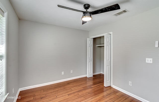 783 Whippoorwill Dr, Brandon, MS 39047 - unfurnished bedroom featuring wood finished floors, a ceiling fan, and a closet