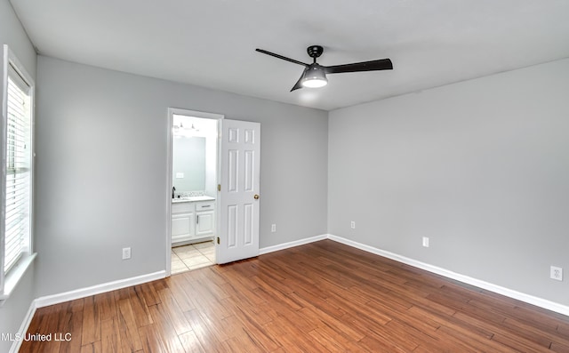 783 Whippoorwill Dr, Brandon, MS 39047 - unfurnished bedroom with wood finished floors, ensuite bathroom, and ceiling fan