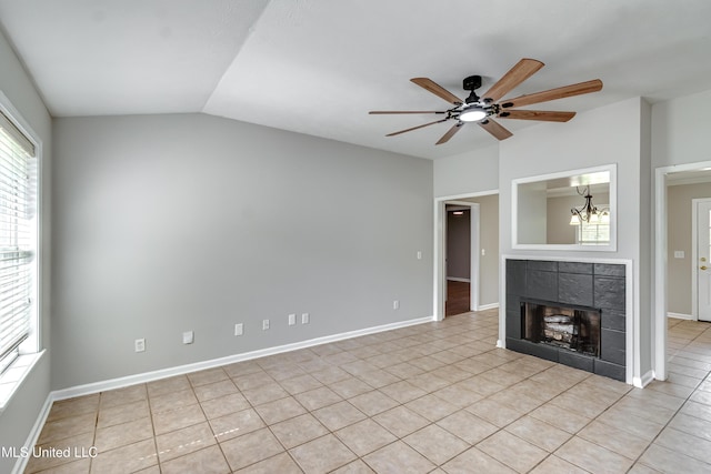 783 Whippoorwill Dr, Brandon, MS 39047 - unfurnished living room with a ceiling fan, light tile patterned floors, a tiled fireplace, lofted ceiling, and a chandelier