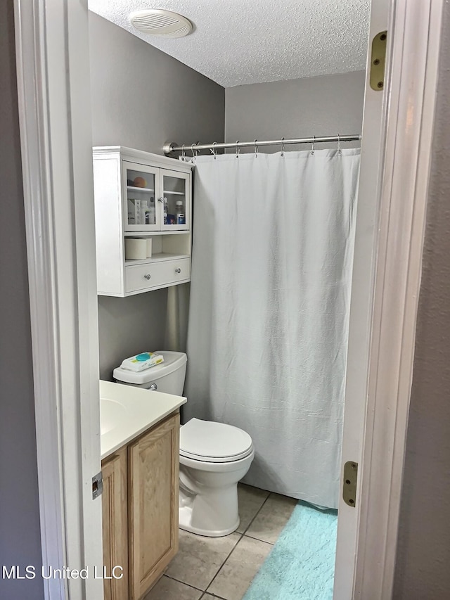8617 Pinoak Ln, Ocean Springs, MS 39564 - bathroom with a textured ceiling, vanity, tile patterned flooring, and a shower with curtain
