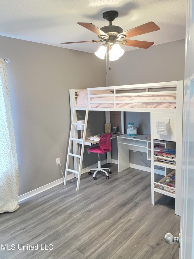 8617 Pinoak Ln, Ocean Springs, MS 39564 - bedroom with wood finished floors, an office area, and a ceiling fan