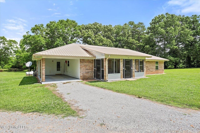 869 B Parks Rd, Pickens, MS 39146 - ranch-style house featuring driveway, metal roof, a front yard, and a sunroom