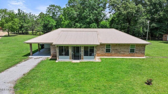 869 B Parks Rd, Pickens, MS 39146 - back of house featuring brick siding, driveway, a yard, metal roof, and an attached carport
