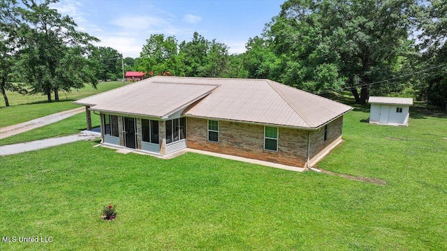 869 B Parks Rd, Pickens, MS 39146 - view of front of house featuring a sunroom, a front lawn, and an outbuilding