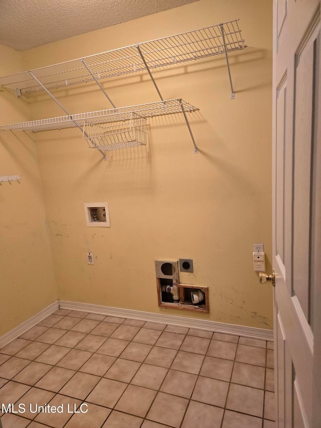 washroom featuring tile patterned floors, electric dryer hookup, a textured ceiling, and hookup for a washing machine