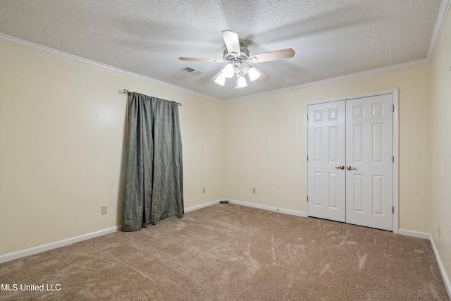 unfurnished bedroom featuring ceiling fan, light colored carpet, and a textured ceiling