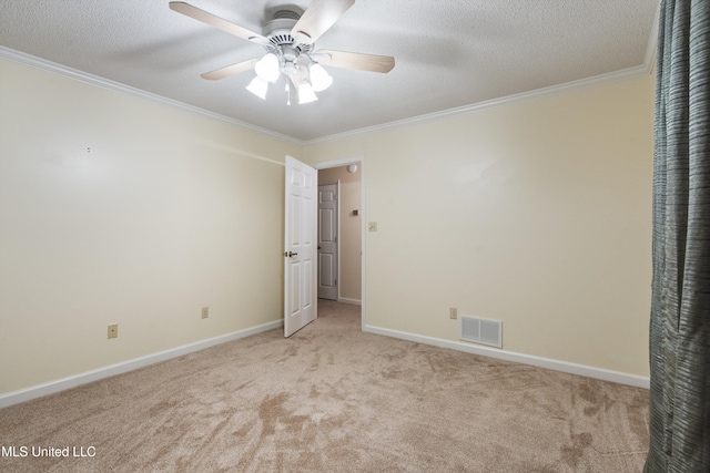 unfurnished bedroom with a textured ceiling, light colored carpet, ceiling fan, and crown molding