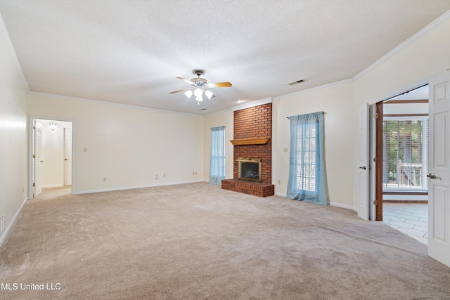 unfurnished living room featuring light carpet, a textured ceiling, a brick fireplace, and ornamental molding