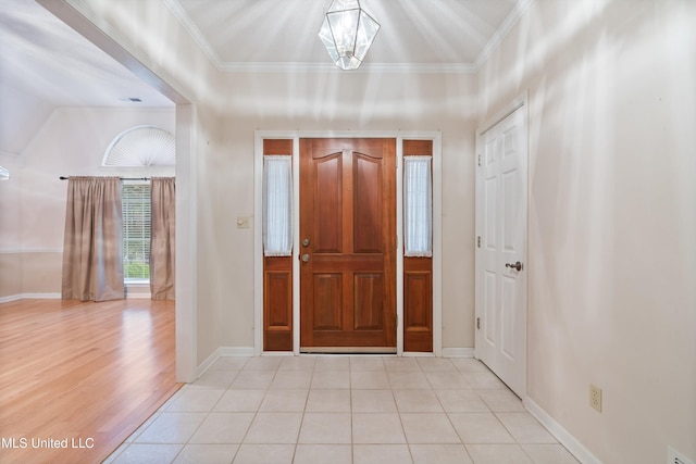 entryway featuring a chandelier, crown molding, and light hardwood / wood-style flooring