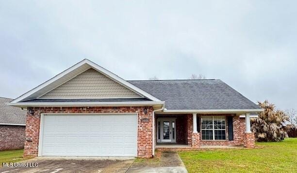 view of front of property featuring a garage, concrete driveway, brick siding, and a front lawn