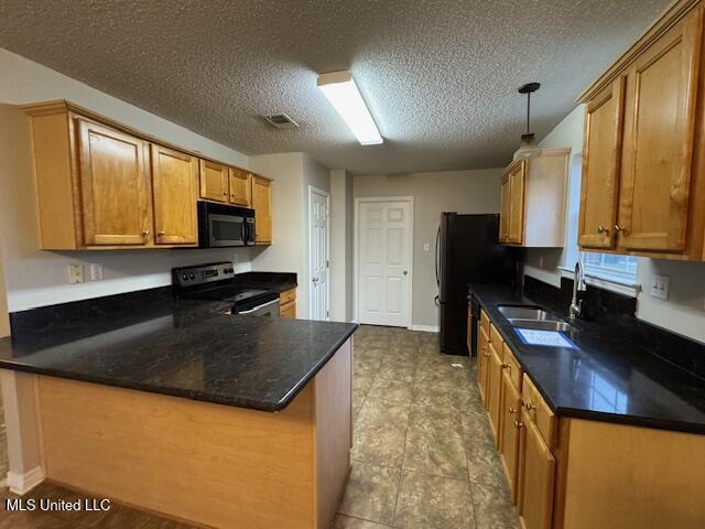 kitchen featuring dark countertops, black appliances, and decorative light fixtures