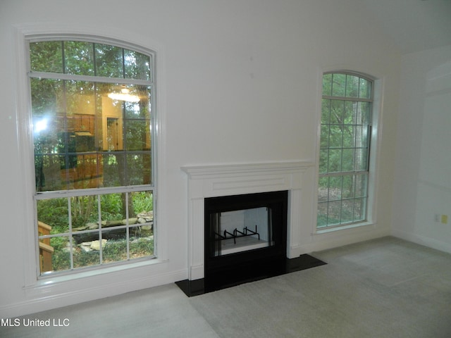 7890 Hilo Way, Diamondhead, MS 39525 - unfurnished living room featuring carpet flooring, a fireplace with flush hearth, and baseboards