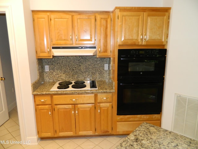7890 Hilo Way, Diamondhead, MS 39525 - kitchen featuring under cabinet range hood, white electric stovetop, light tile patterned floors, and tasteful backsplash