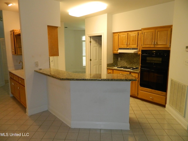 7890 Hilo Way, Diamondhead, MS 39525 - kitchen with under cabinet range hood, light tile patterned floors, tasteful backsplash, a sink, and white gas stovetop