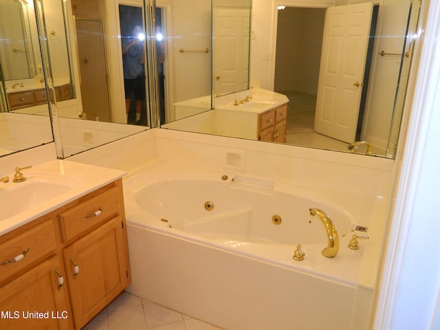 7890 Hilo Way, Diamondhead, MS 39525 - bathroom with tile patterned flooring, a jetted tub, and vanity
