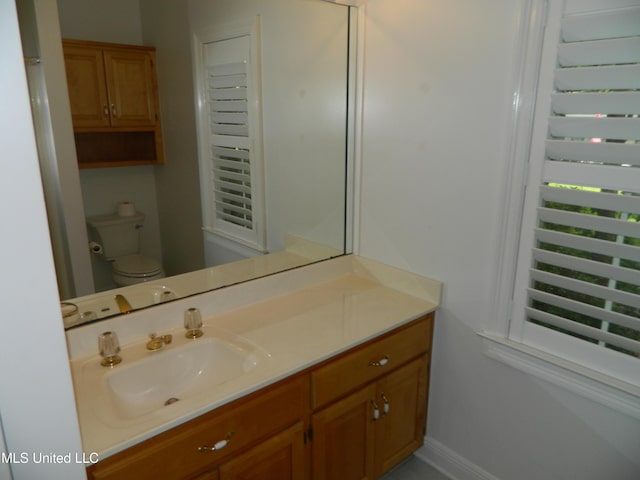 7890 Hilo Way, Diamondhead, MS 39525 - bathroom featuring vanity, toilet, and baseboards