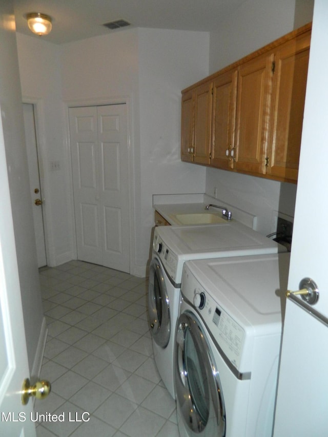 7890 Hilo Way, Diamondhead, MS 39525 - washroom with cabinet space, washer and dryer, and light tile patterned floors