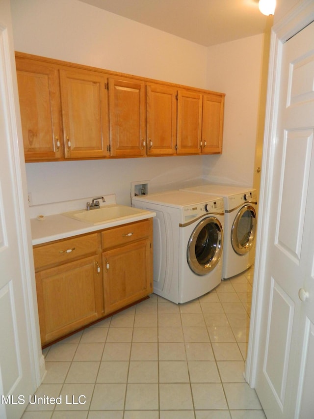 7890 Hilo Way, Diamondhead, MS 39525 - washroom featuring cabinet space, light tile patterned floors, and washer and clothes dryer