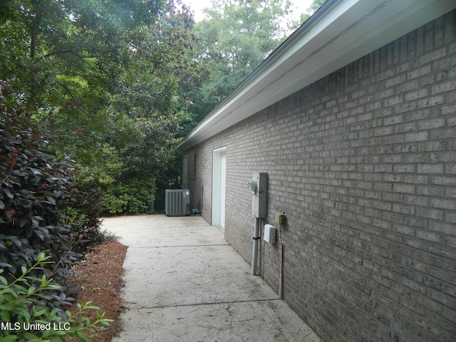 7890 Hilo Way, Diamondhead, MS 39525 - view of side of home featuring brick siding and cooling unit