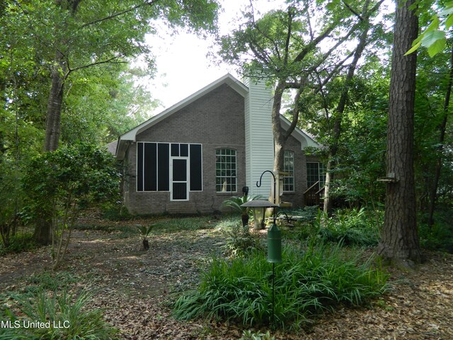 7890 Hilo Way, Diamondhead, MS 39525 - back of property with brick siding and a chimney