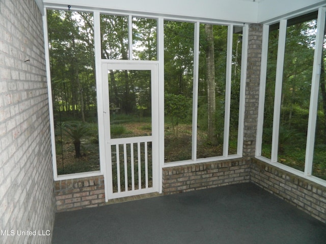 7890 Hilo Way, Diamondhead, MS 39525 - unfurnished sunroom with brick wall and healthy amount of natural light