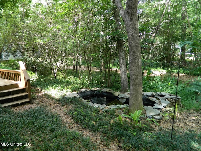 7890 Hilo Way, Diamondhead, MS 39525 - view of yard featuring a wooden deck