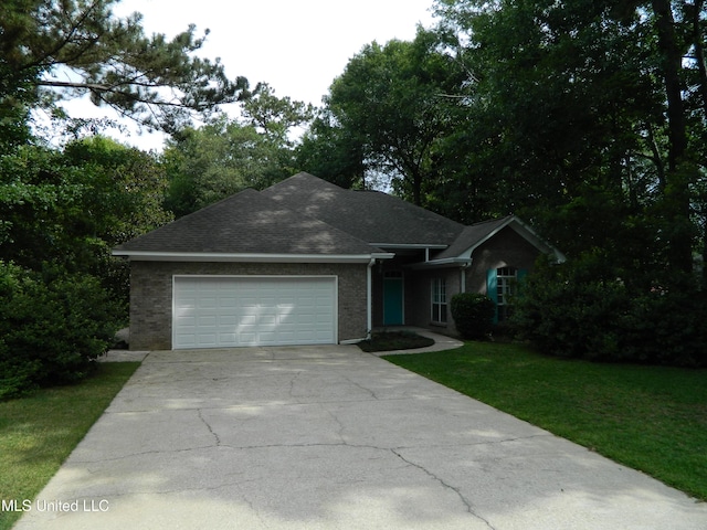 7890 Hilo Way, Diamondhead, MS 39525 - ranch-style house featuring a garage, driveway, a front lawn, brick siding, and roof with shingles