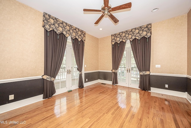 1401 Ladnier Rd, Gautier, MS 39553 - unfurnished room with french doors, wallpapered walls, a ceiling fan, and wood finished floors