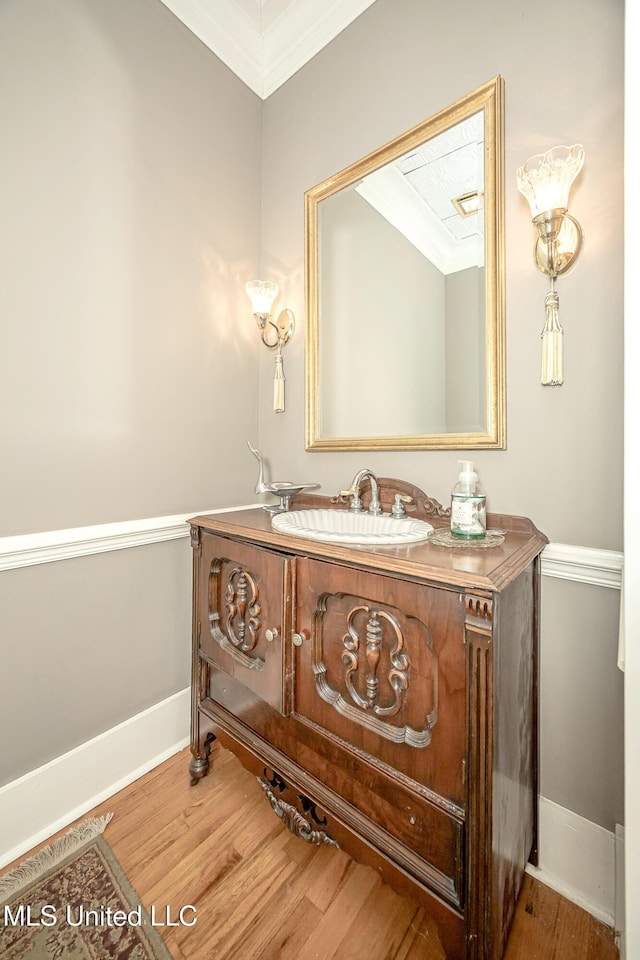 1401 Ladnier Rd, Gautier, MS 39553 - bathroom featuring baseboards, wood finished floors, ornamental molding, and vanity