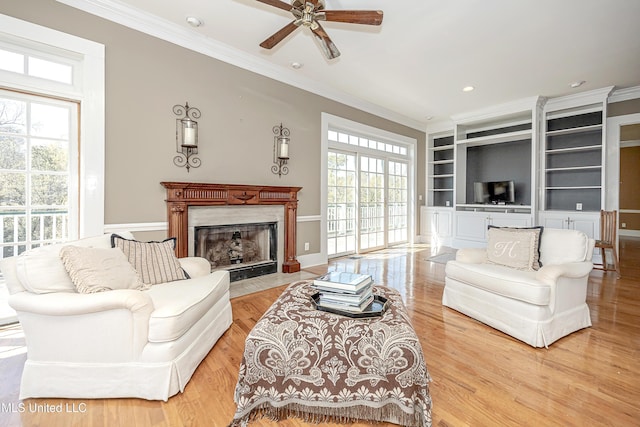 1401 Ladnier Rd, Gautier, MS 39553 - living area featuring plenty of natural light, crown molding, a high end fireplace, and a ceiling fan